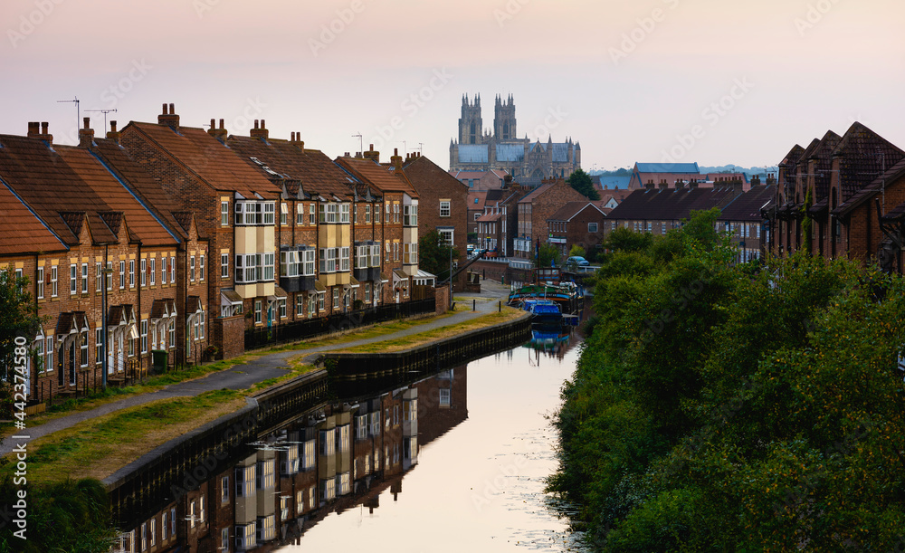 The Minster, beck, and townhouses at sunset, Beverley, Yorkshire, UK.
