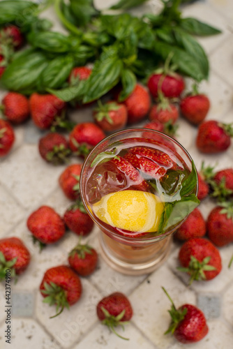 Refreshing drink. Lemonade with strawberries and lemon. Summer cocktail. Strawberry lemonade with basil. Country rest