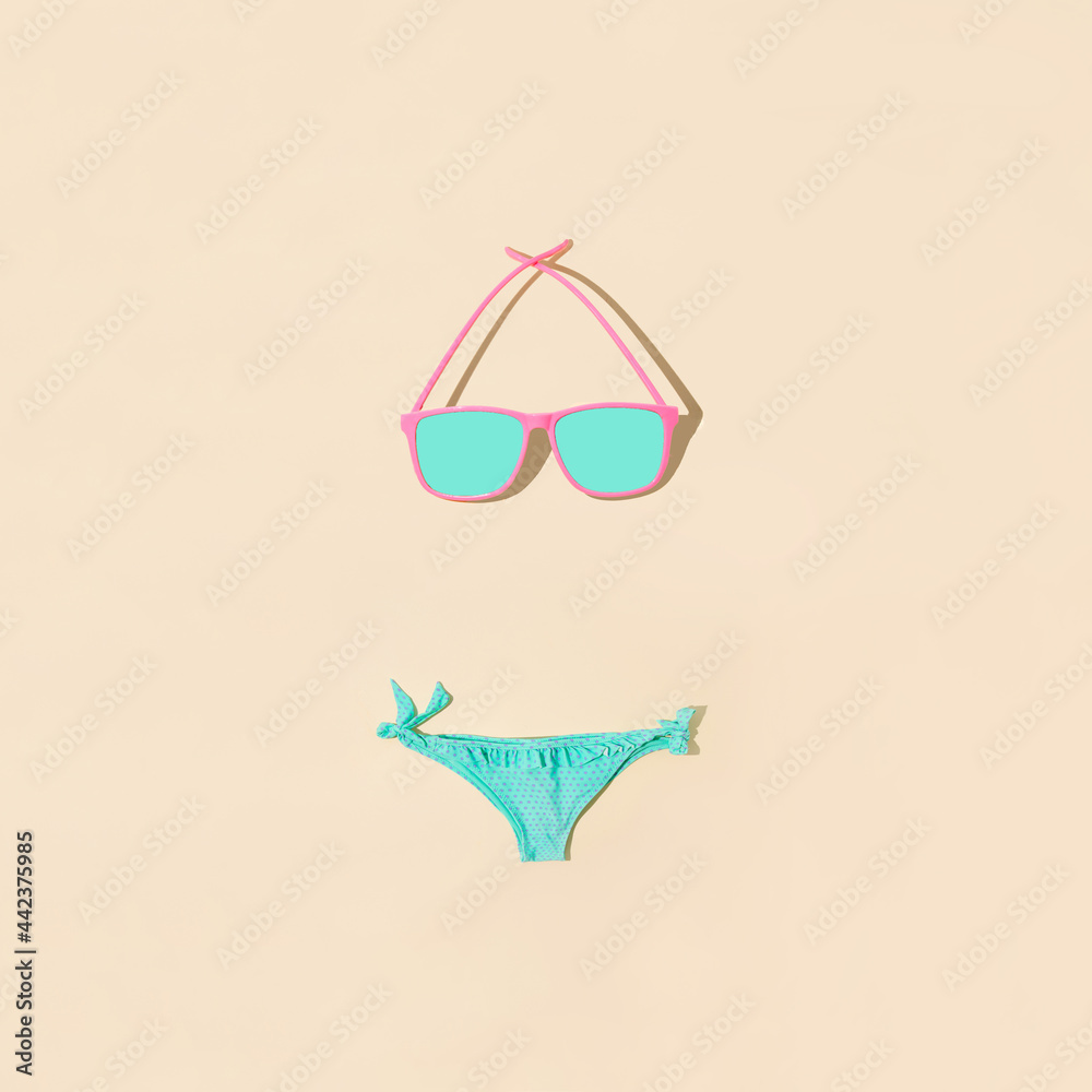 Beach swimwear. Glasses as the upper part of the swimsuit. Minimum summer composition. On nude backgrounds.