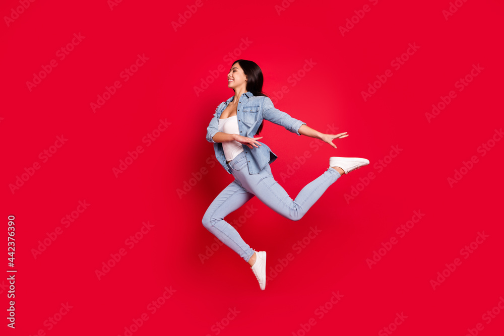 Full length body size view of attractive cheerful girl jumping dancing moving modern isolated over bright red color background