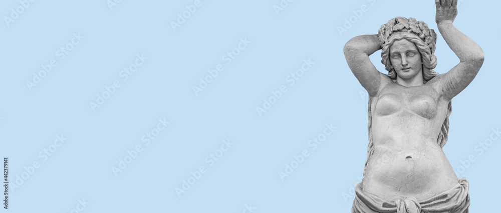 Ancient statue of beautiful topless Roman woman of Renaissance Era at blue sky background and copy space for text, details, closeup