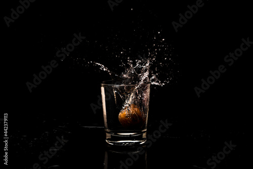 High resolution water splash freeze motion from a clean glass of water with droplet and bubble formation