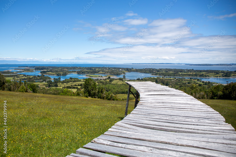 Dock of the islands viewpoint, located on Mechuque Island, Chiloé in southern Chile. With blue sky with some clouds