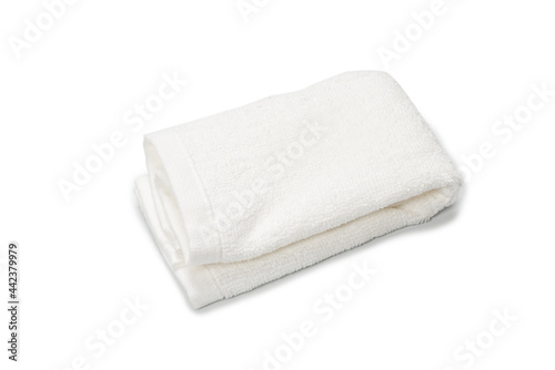 White fluffy cotton towel isolated on a white background.