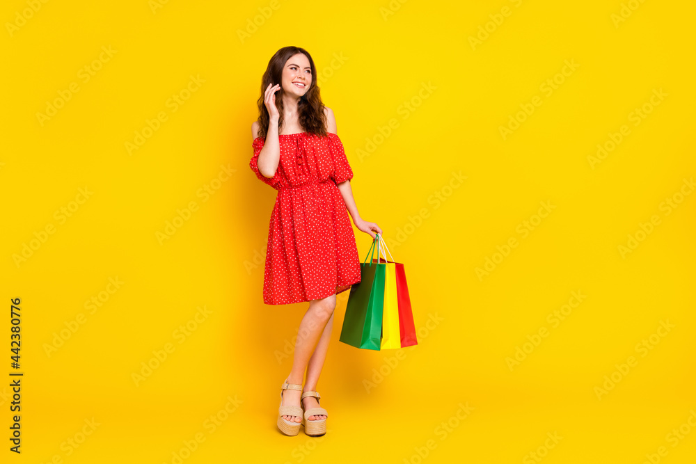 Full size portrait of pretty positive lady hand touch hair look empty space isolated on yellow color background