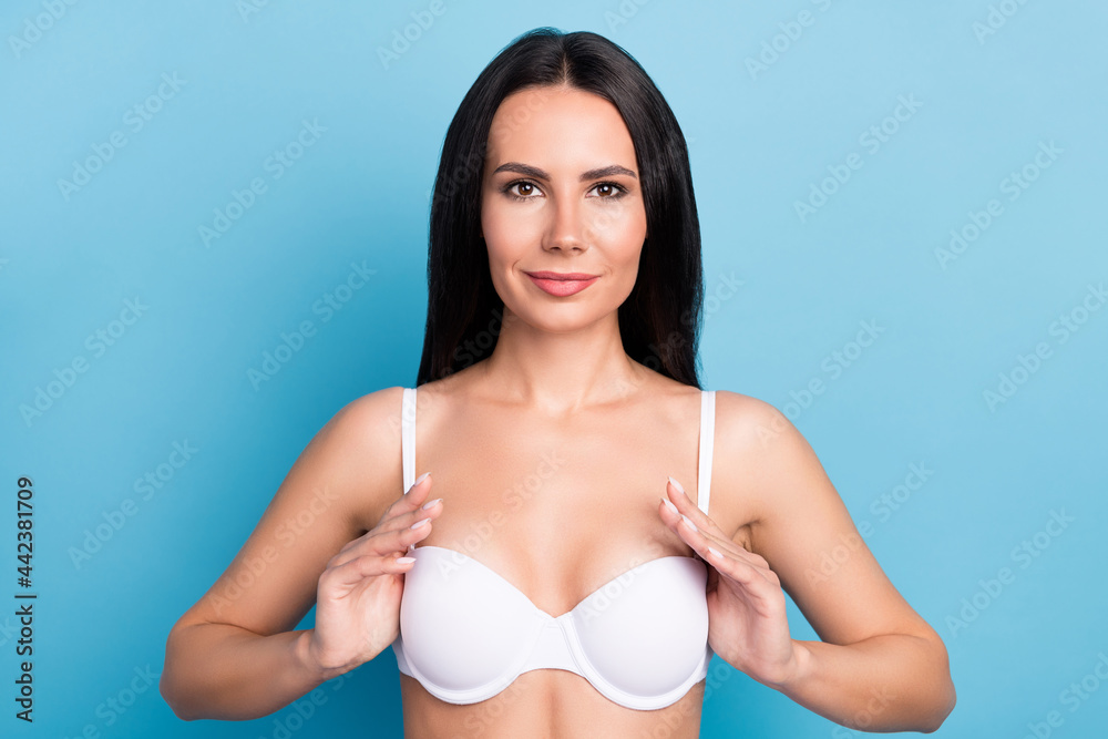 Obraz premium Portrait of pretty positive lady hands touch breast showing results look camera isolated on blue color background