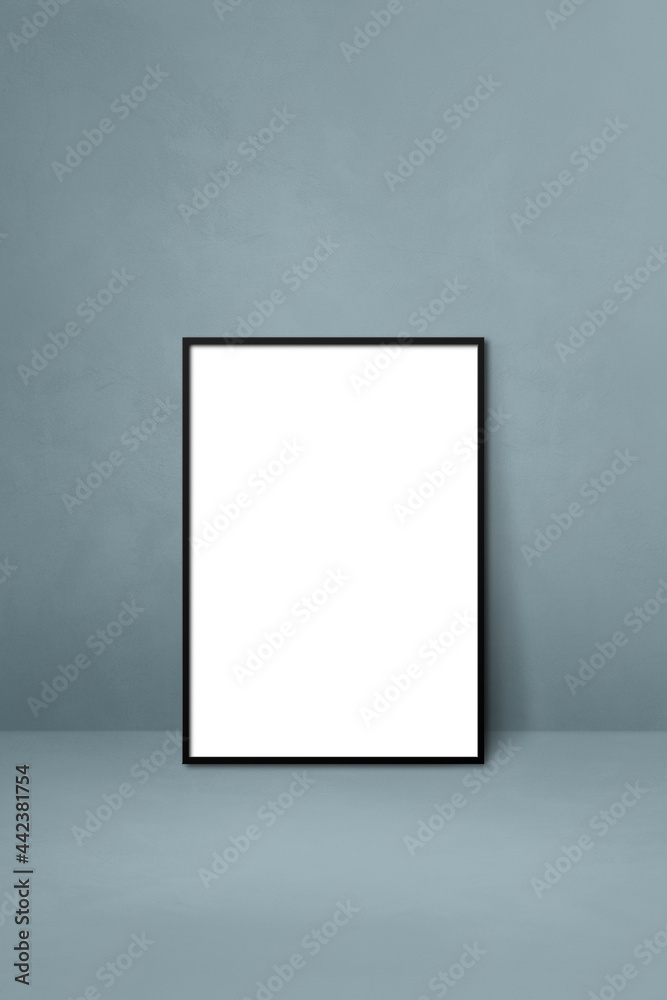 Black picture frame leaning on a grey wall Black picture frame leaning on a grey wall