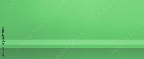 Empty shelf on a green wall. Background template. Horizontal banner