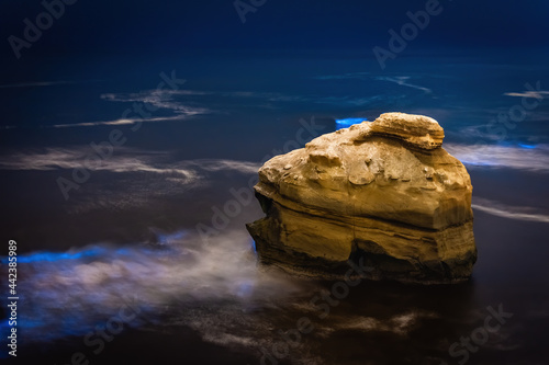 Bioluminescence glowing electric blue in the Pacific Ocean in San Diego California at Sunset Cliffs  photo