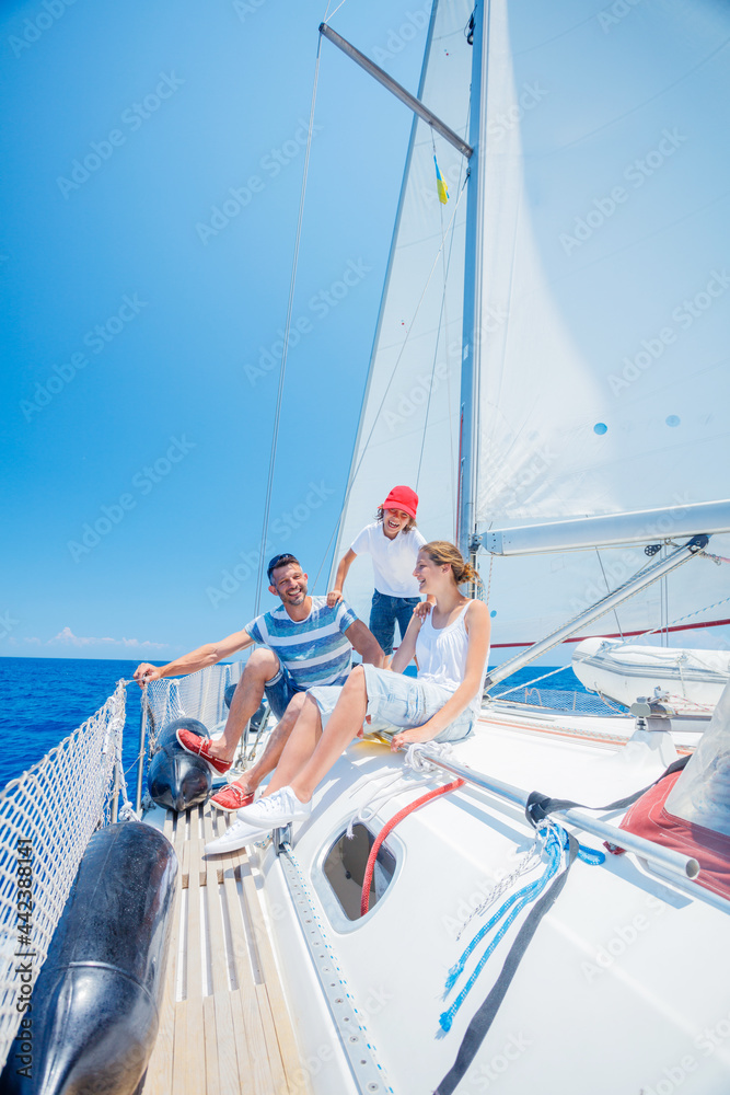 Family with adorable kids resting on yacht Family with adorable kids resting on yacht