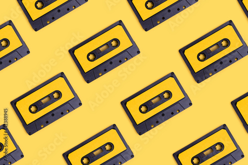 Cassette tapes pattern on a yellow background. Creative concept.