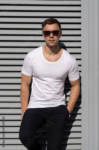 handsome sexy man in white t-shirt and sunglasses, white t-shirt mockup front view