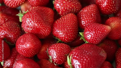 Background of ripe juicy strawberries.  Slow camera movement. Selective focus