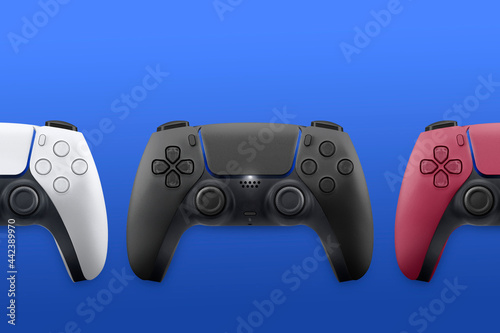 White, black and red next generation game controllers on blue background. Top view.