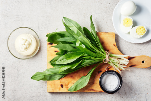Fresh wild garlic on a cutting board.
