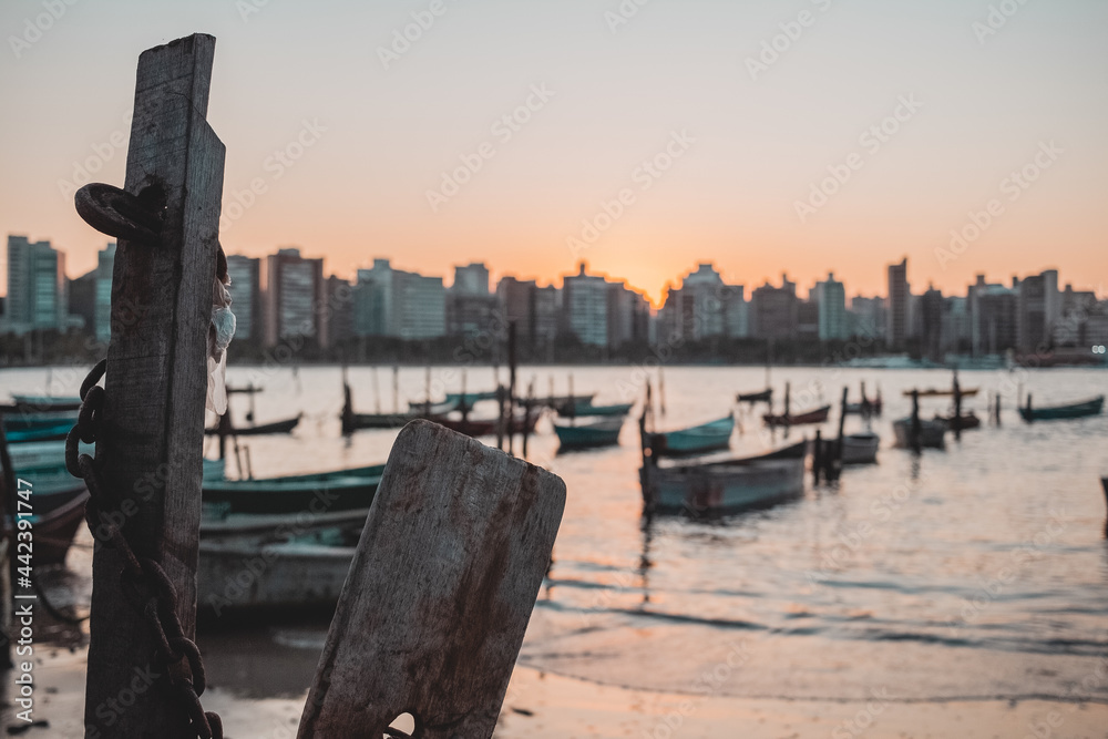 Praia de Vitória, Brazil in a beautiful sunset in a clear autumn afternoon, showing the presence of many fishing boats usually moored in the region.