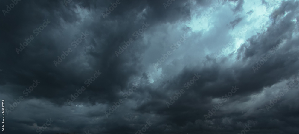 The dark sky had clouds gathered to the left and a strong storm before it rained.Bad or moody weather sky. The dark sky had clouds gathered to the left and a strong storm before it rained.Bad or moody weather sky.