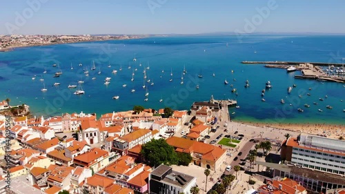 Ocean view in Cascais, Portugal. Many sailboats in one place, a view from a height. European houses with red tiles from a height.