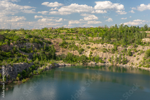 landscape of a granite quarry against a summer cloudy sky