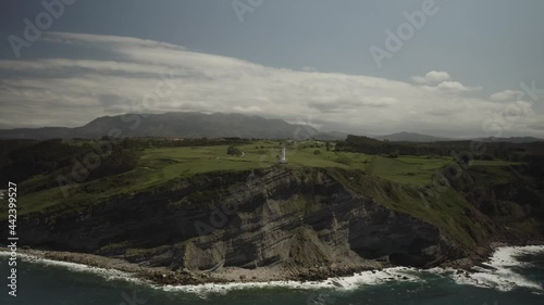 Aerial video view of the Luces lighthouse in Colunga, Asturias. Spain. photo