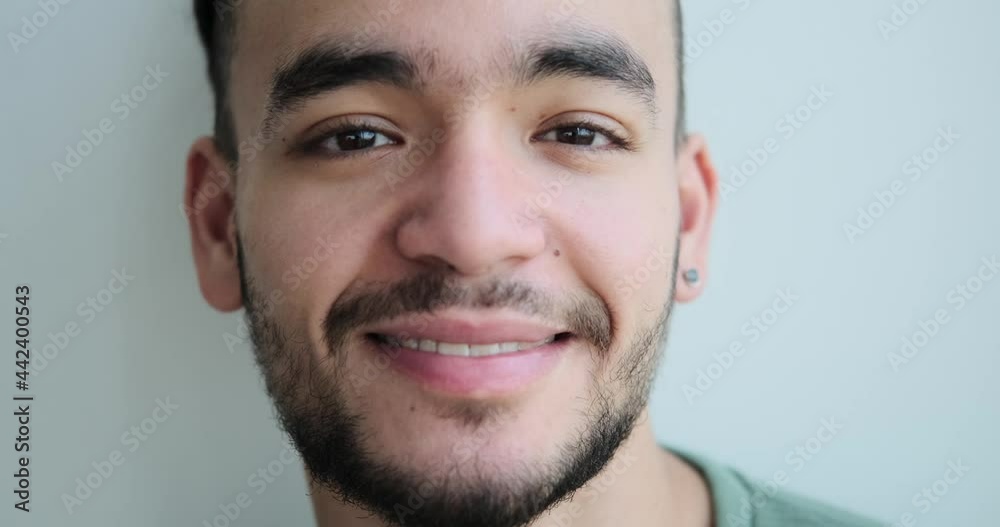 Face of thoughtful young man smiling at home Face of thoughtful young man smiling at home