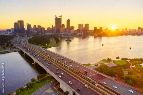 Aerial of the sunrise over the Perth skyline with morning traffic on the Narrows Bridge and river. photo