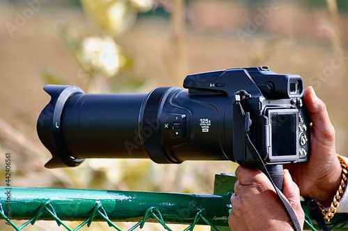 camera in hand - Nikon camera , Nikon p1000
