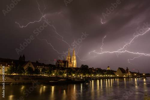 Gewitter über Regensburg am Abend mit Blitzen und Dome beleuchtet photo