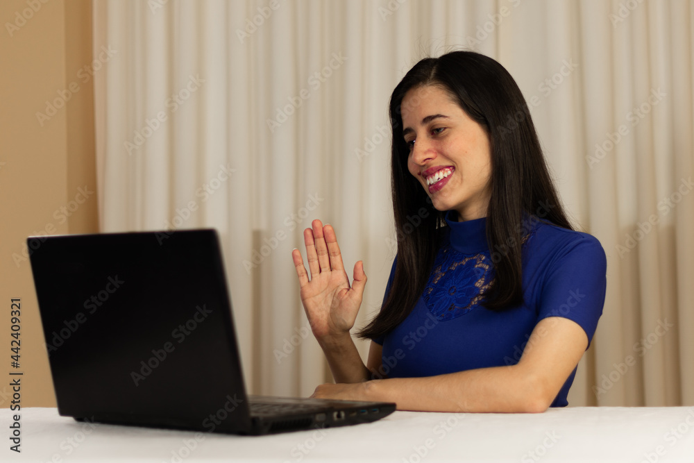 waving to laptop, left handed, right hand. woman working on laptop. Person talking on the computer, laptop. giving classes, exposing. virtual. isolated. Latin woman waving to laptop, left handed, right hand. woman working on laptop. Person talking on the computer, laptop. giving classes, exposing. virtual. isolated. Latin woman