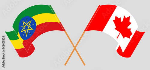Crossed and waving flags of Ethiopia and Canada