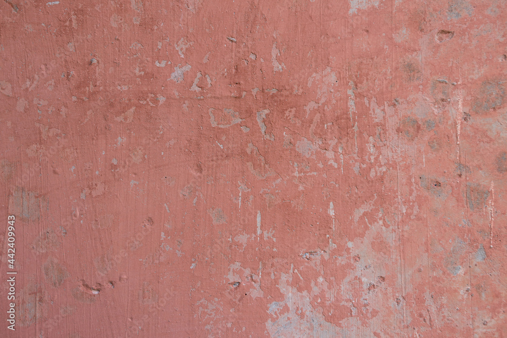 Light red pink concrete wall with cracked peeling paint texture Light red pink concrete wall with cracked peeling paint texture