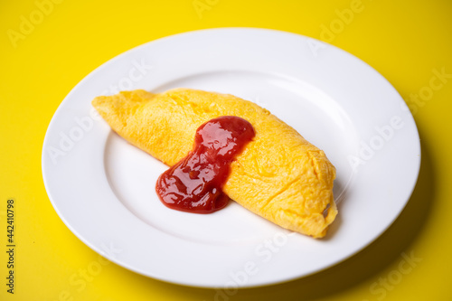 Obraz na płótnie plain omelette with tomato ketchup on yellow background