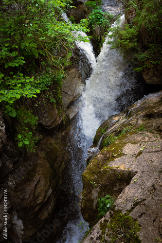 Beautiful waterfall with a stunning forest in the background on a nice sunny day.