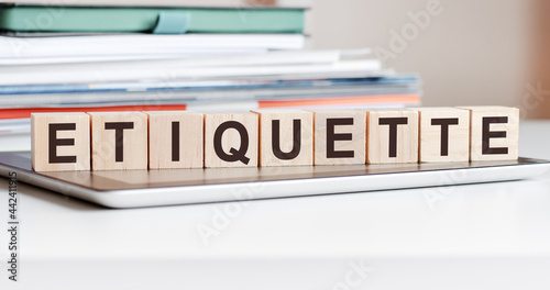 the word etiquette is written on wooden cubes, concept