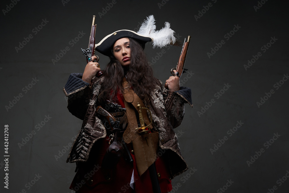 Fototapeta premium Barbaric woman pirate holding dual flintlock pistols