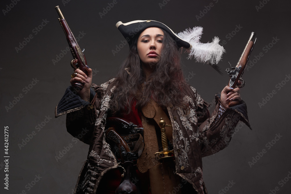 Fototapeta premium Brunette caribbean corsair with dual flintlock guns