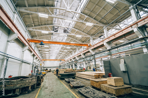 Large industrial warehouse or workshop in modern factory. Woodworking workshop interior. © DedMityay