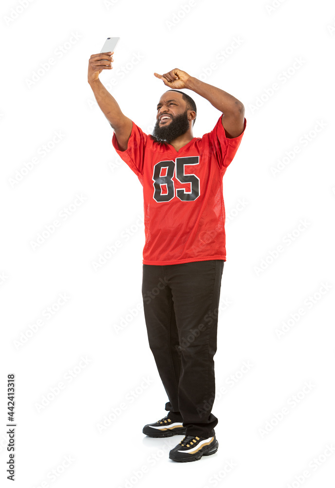 Naklejka premium Fan: Sports Man Takes Selfie With Cell Phone