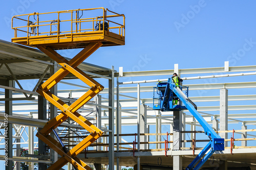 mobile self propelled hydraulic lifting platform and scissor lift in action photo