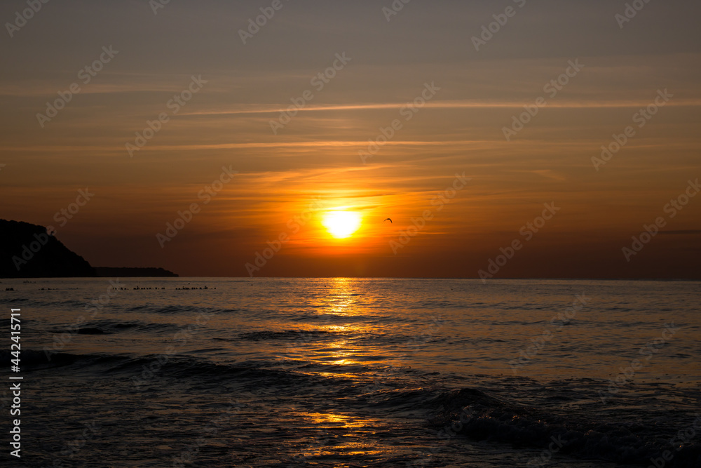 beautiful sunset on the sea. beach and surf at sunset.