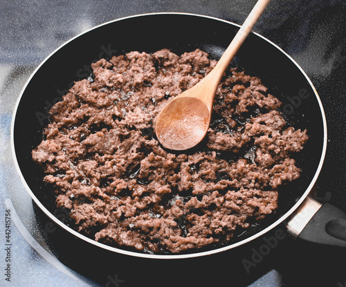 Slika na platnu Ground hamburger beef in stir fry pan.