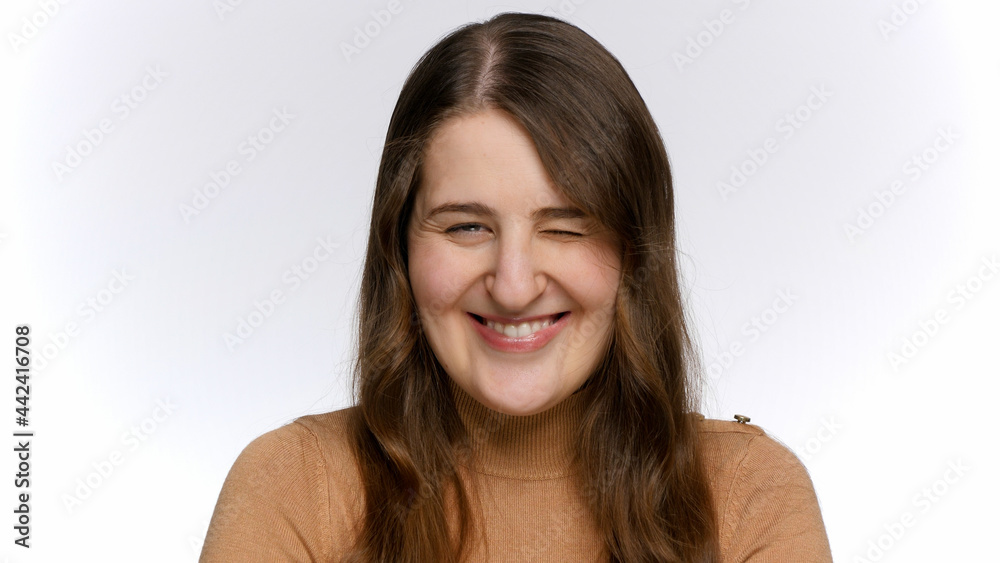 Portrait of smiling young woman looking in camera and winking with eye. Portrait of smiling young woman looking in camera and winking with eye.