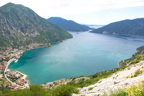 Bay of Kotor  view from above. You can see the vast Adriatic Sea and the town of Risan  which are surrounded by rocky mountains.