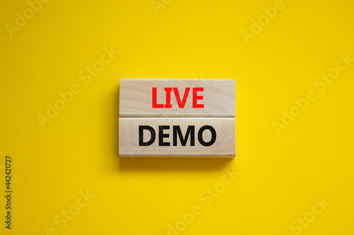 Live demo symbol. Concept words 'live demo' on wooden blocks on a beautiful yellow background. Copy space. Business and live demo concept. photo
