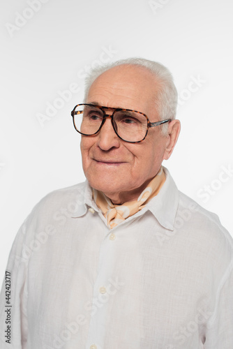 portrait of smiling elderly man in glasses isolated on white