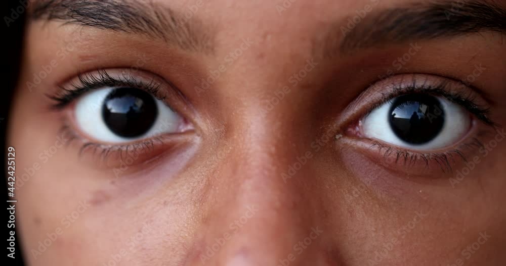 Black child eyes wide open looking at camera macro close-up