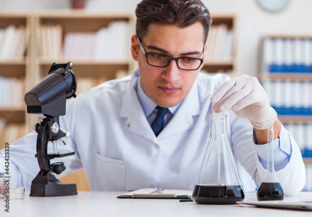 Chemical engineer working on oil samples in lab Chemical engineer working on oil samples in lab