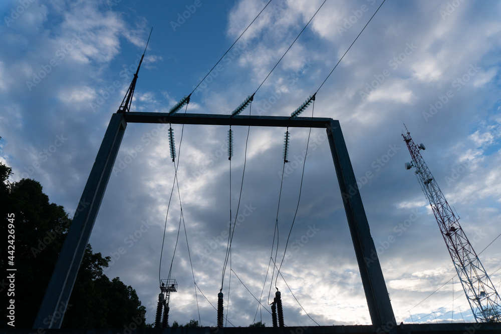 custom made wallpaper toronto digitalcritical electrical infrastructure with high-voltage transmission lines and a communication tower, highlighting the importance of power distribution and energy security against a cloudy sky