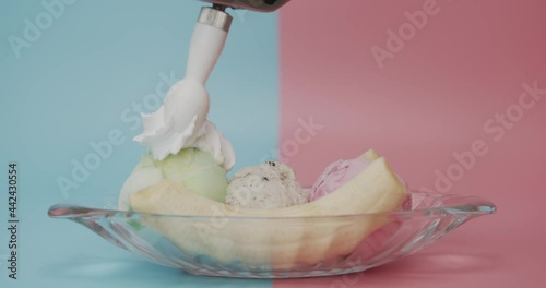 Close-up detail Topping Whip cream ice cream lemon lime - Cookies and Cream - Strawberry Banana Split on blue pink background.  photo