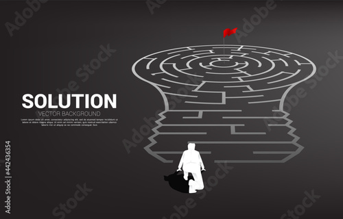 Silhouette of businessman ready to go to Light bulb with from maze game. Business concept for problem solving and finding idea.